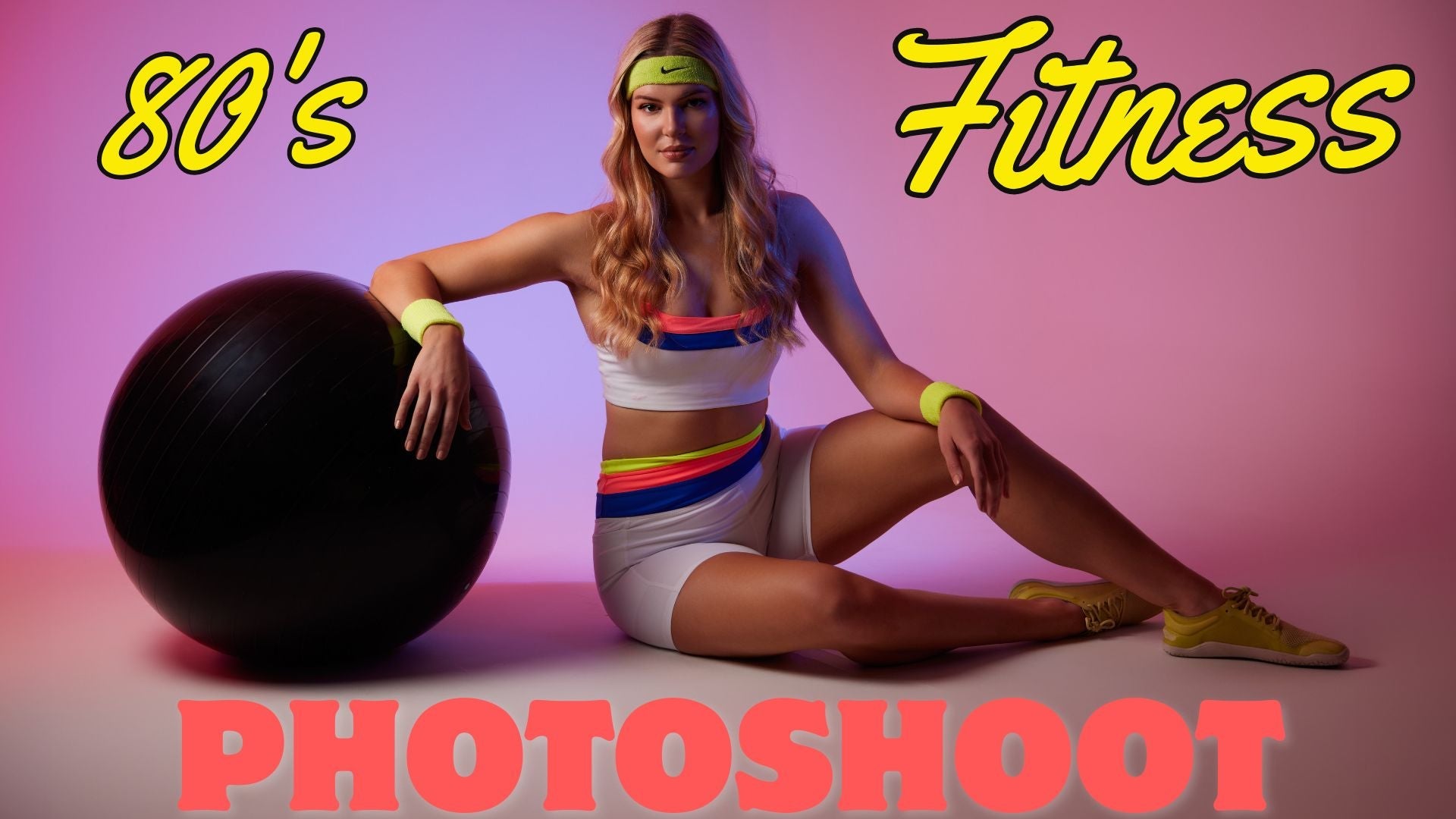 80's fitness photoshoot with model in retro workout gear against pink background.